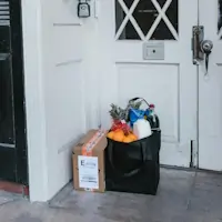 An open sign in front of a glass door.
